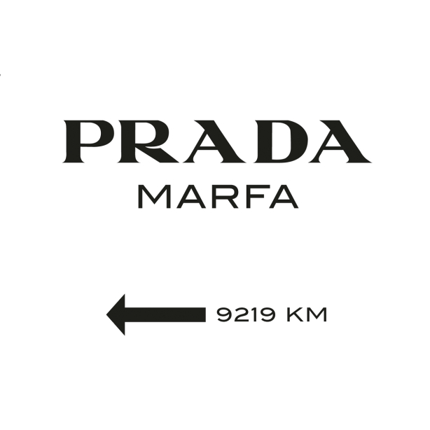 Das Bild zeigt ein Schild mit dem Text "PRADA MARFA" über einem nach links zeigenden Pfeil und der Angabe "9219 KM."